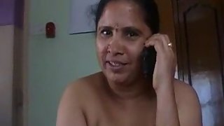 mature Indian jerking her mans cock naked while on the phone